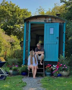 a man and a woman sitting in a shed at Elderflower Hut in Port Isaac