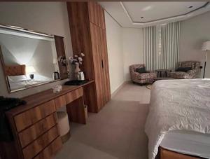 a bedroom with a bed and a large mirror at الريمية in Al Madinah +5 photos