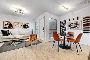 a living room with a couch and a table and chairs at Artist Retreat by SoCo - Sleeps 4 - Free Parking in Austin