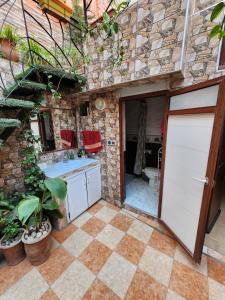 an outdoor kitchen with a sink and a toilet at Quadra Sphere rooftop in Tamraght Ouzdar