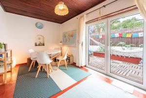 a dining room with a table and a large window at Casa da Rita in Cascais +29 photos