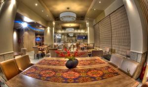 a dining room with a table and chairs at Aliakmon Hotel in Kozani