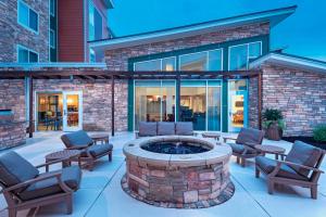 a patio with a fire pit in front of a building at Residence Inn by Marriott Omaha West in Omaha