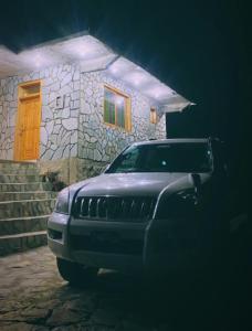 a jeep parked in front of a house at night at Astore Oasis Resort Gorikote in Kine Dās