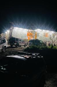a car parked in front of a building at night at Astore Oasis Resort Gorikote in Kine Dās