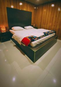 a bedroom with a large bed in a room at Astore Oasis Resort Gorikote in Kine Dās