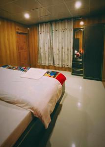 a bedroom with a large bed in a room at Astore Oasis Resort Gorikote in Kine Dās +3 photos