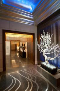 a lobby with a tree in the middle of a building at The St. Regis Osaka in Osaka
