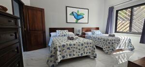 a bedroom with two beds and a window at Villa Pura Vida - All Inclusive in Ocotal +52 photos