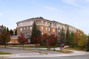 a building with a stop sign in front of a street at Extended Stay America Suites - Denver - Broomfield in Broomfield