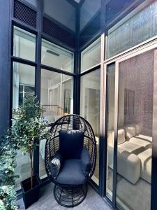 a wicker chair sitting on a porch next to a window at Toronto Downtown Core Condo 2 BED 2 BATH in Toronto