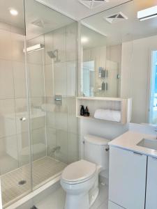 a bathroom with a shower and a toilet and a sink at Toronto Downtown Core Condo 2 BED 2 BATH in Toronto +19 photos