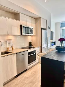 a kitchen with stainless steel appliances and a counter top at Toronto Downtown Core Condo 2 BED 2 BATH in Toronto
