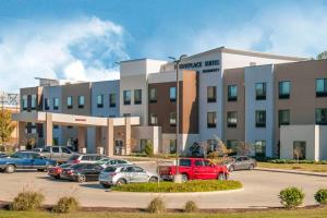 a large building with cars parked in a parking lot at TownePlace Suites by Marriott Vidalia Riverfront in Vidalia