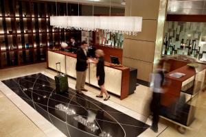 a man and woman standing at a counter in a restaurant at Marriott Montreal Airport In-Terminal Hotel in Dorval