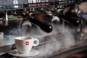 a coffee maker is making a cup of coffee at Marriott Montreal Airport In-Terminal Hotel in Dorval