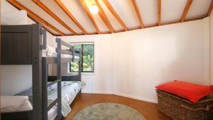 a bedroom with bunk beds and a window at 'The Yurt' by HolidayCo in Hardys Bay +3 photos