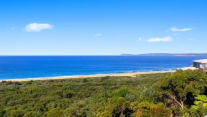 an aerial view of a beach and the ocean at 'The Yurt' by HolidayCo in Hardys Bay