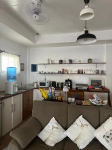 a living room with a couch and a kitchen at Costa Cantagay in Jagna