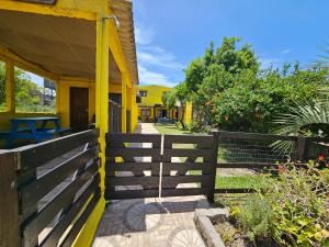 a wooden fence next to a house at Mirador del Diablo in Punta Del Diablo