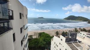 a view of the beach from a building at Cobertura Luxuosa, pe na areia - Exclusividade na Praia do Tombo, Guarujá, a Mais Premiada com Bandeira Azul no Brasil in Guarujá