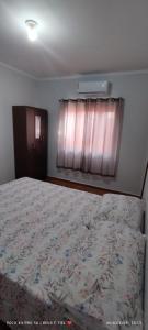 En eller flere senge i et værelse på Casa JARDIM AMÉRICA