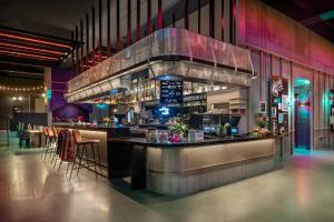 a bar in a restaurant with a bar counter at Moxy Portland Downtown in Portland
