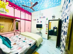 a bedroom with a bed and a ceiling fan at Its Home - Stay in Aurangabad