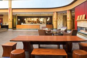 a lobby with tables and chairs and a bar at Sheraton Anchorage Hotel in Anchorage