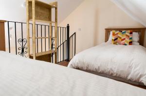 a bedroom with two beds and a staircase at Kylemore house boutique apartments - Diamond Lounge in Kylemore