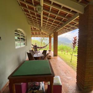 a patio with a table and chairs and a view at Chácara Palma in Ubatuba +19 photos