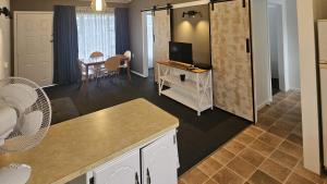 a room with a kitchen and a living room at Frimley Lodge Motel - with Airport Shuttle service- Best Location in Town in Hastings