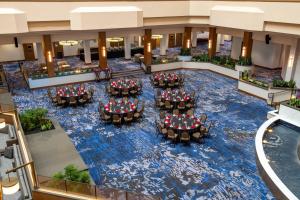 an overhead view of the lobby of a hotel with tables and chairs at Madison Marriott West in Middleton
