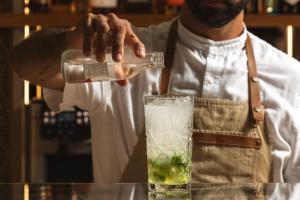 a man in a kitchen preparing a drink at Sheraton Cascais Resort - Hotel & Residences in Cascais