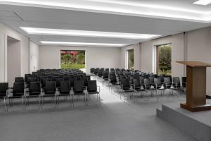 an empty room with black chairs and a podium at Sheraton Cascais Resort - Hotel & Residences in Cascais