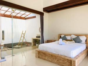 a bedroom with a large bed and a glass enclosure at Volcano Side Kintamani Bali in Kintamani