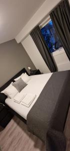 a large bed in a room with a window at Modern and Central Apartment, 6 mins to Oslo City in Oslo