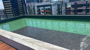 a swimming pool on the roof of a building at Flat Manaira in João Pessoa