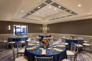 a ballroom with blue tables and chairs and a room at Portland Sheraton at Sable Oaks in South Portland