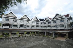 a large white building with a parking lot in front at Vista Hotel Chiang Mai - SHA EXTRA PLUS in Chiang Mai