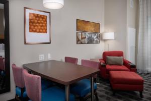a waiting room with a table and chairs at TownePlace Suites Fort Worth Northwest Lake Worth in Fort Worth +21 photos