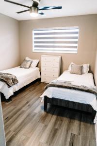 a bedroom with two beds and a window at Welcome to 305 Rentals in Miami Gardens