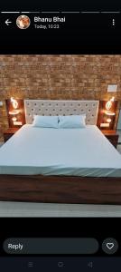 a bedroom with a bed with a white bedspread at Maa kamakhya home stay in Varanasi