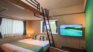 A bed or beds in a room at サンメール座間味アネックス