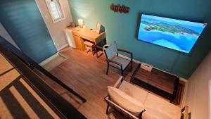 A television and/or entertainment centre at サンメール座間味アネックス