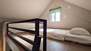 A bed or beds in a room at サンメール座間味アネックス