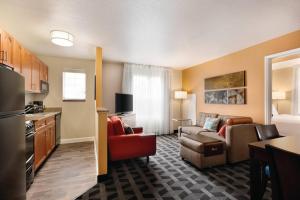 a kitchen and a living room with a couch and a room at Ville 7877 in Centennial