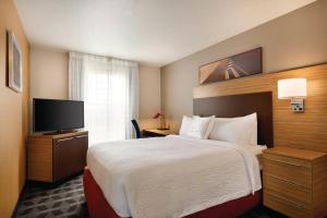 a hotel room with a bed and a flat screen tv at Ville 7877 in Centennial