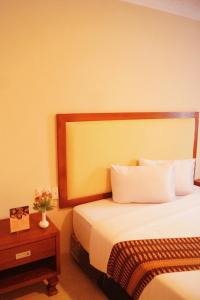 Ένα ή περισσότερα κρεβάτια σε δωμάτιο στο Sultan Hotel Banda Aceh