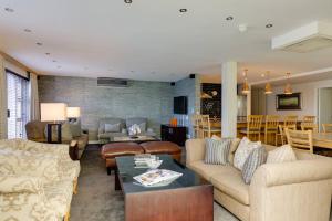 a living room with couches and a table at Protea Hotel by Marriott Knysna Quays in Knysna